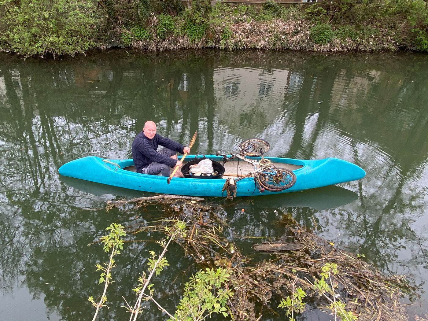 The Save Our Stort volunteer team on the towpath beside a haul of litter pulled from the river, including a fridge, a bike, a tyre and bags of rubbish